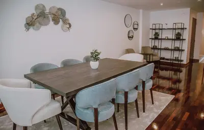 a dining room with a wooden table and chairs at Departamento Premium De Estreno En Miraflores in Lima