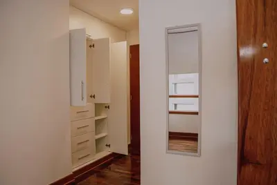 a room with white cabinets and a mirror at Departamento Premium De Estreno En Miraflores in Lima