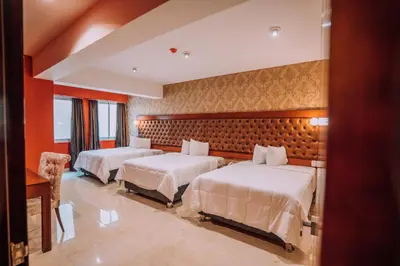 two beds in a hotel room with red walls at Lima Central Design Hotel Spa & Club in Lima