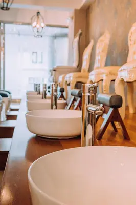 a row of sinks on a counter in a bathroom at Lima Central Design Hotel Spa & Club in Lima
