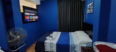 a blue room with a bed and a fan at 300 Departamento Centrico distrito de chorrillos in Lima