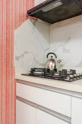 a tea kettle sitting on top of a stove at Loft abierto y moderno & Aire acondicionado in Lima