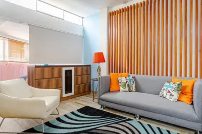 a living room with a couch and a chair at Loft abierto y moderno & Aire acondicionado in Lima