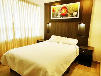 a bedroom with a white bed and a window at Villa blanca in Andahuaylas