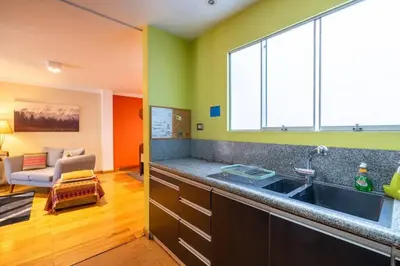 a kitchen with a sink and a large window at Balconcito Peruano & AMPLIO 2 dormitorios in Lima