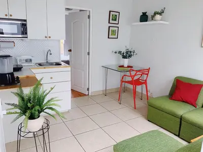 a kitchen and a living room with a couch and a table at Parque & Mar lindo alojamiento en San Isidro in Lima