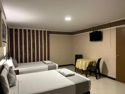a hotel room with two beds and a table at GOLDEN DREAM´S in Lima