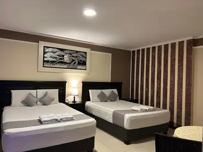 a hotel room with two beds and a table at GOLDEN DREAM´S in Lima