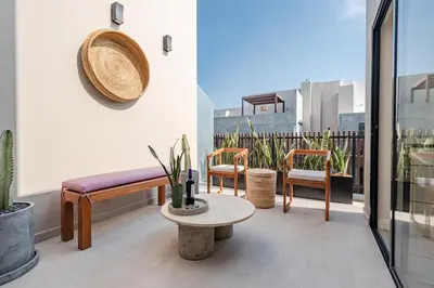 a balcony with a bench and chairs and a table at ✶ Nazca Penthouse ✶ 3-stories LUXURY Rooftop Pool in Lima