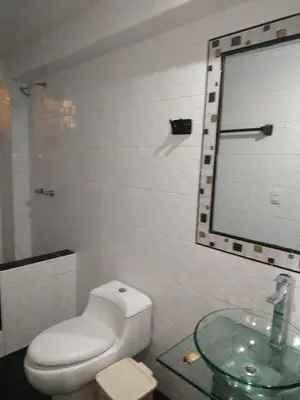 a bathroom with a toilet and a glass sink at Quilla House Ecologico in Machu Picchu