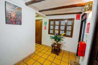 a hallway with a vase of flowers on a table at Vilas Insight Hotel Machupicchu in Machu Picchu