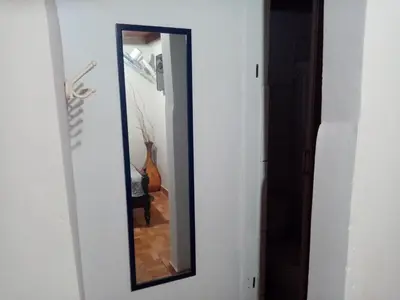 a mirror on a wall in a hallway at La Casa Maruja Habitación doble P in San Bartolo