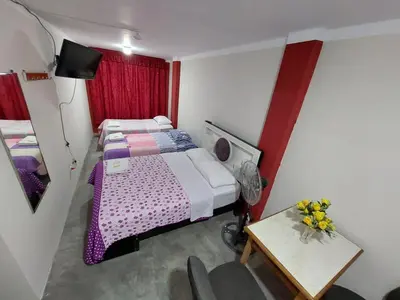a small room with a bed and a small table at La Esquina de Doña Julia in Lima