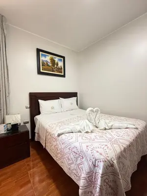 a bedroom with a bed and a picture on the wall at Hotel Luz de Luna in Atico