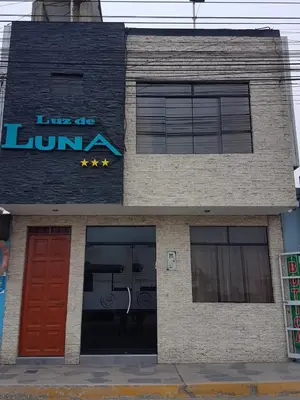 a building with a red door and a gym at Hotel Luz de Luna in Atico
