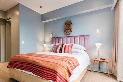 a bedroom with a large bed with blue walls at ✶ Pisac Penthouse ✶ 3-stories LUXURY Rooftop Pool in Lima