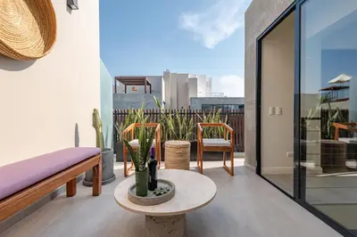 a balcony with a bench and a table and chairs at ✶ Pisac Penthouse ✶ 3-stories LUXURY Rooftop Pool in Lima