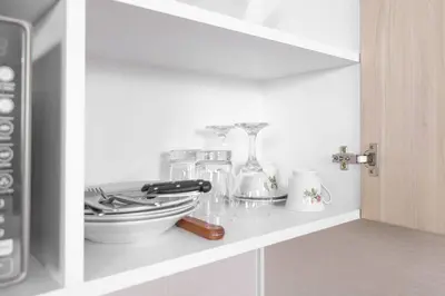 a shelf with a bunch of kitchen items on it at Residencial Suiza in Lima