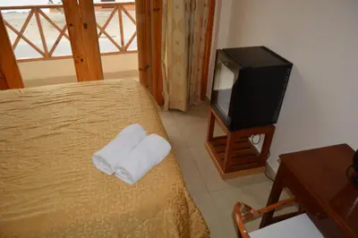 a bedroom with a bed and a television at Hotel Los Flamencos in Paracas