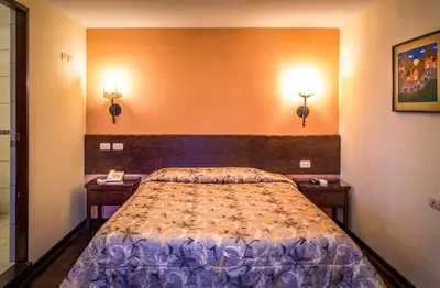 a bedroom with a bed with two night stands at Llaqta Wasi in Lima