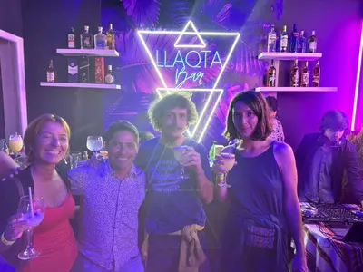 a group of people posing for a picture in a bar at Llaqta Wasi in Lima
