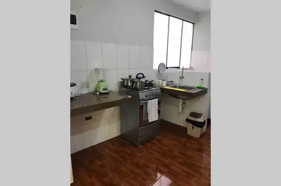 a small kitchen with a sink and a stove at 200. Hermoso Departamento con Servicios Incluidos en Chorrillos in Lima