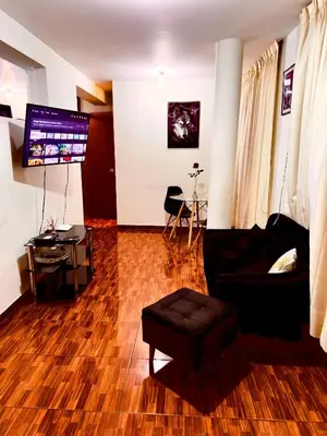 a living room with a couch and a table at 200. Hermoso Departamento con Servicios Incluidos en Chorrillos in Lima