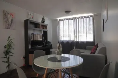 a living room with a table and a couch at Qurpawasi in Lima