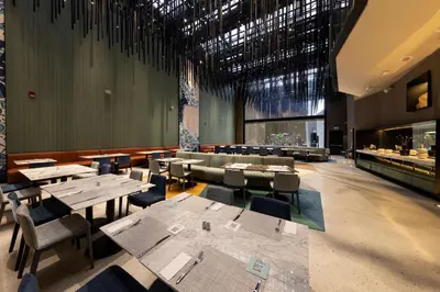a restaurant with tables and chairs in a room at Hilton Garden Inn Lima Miraflores in Lima