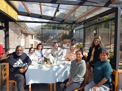 a group of people are sitting around a table at Casa Agustina in Cusco