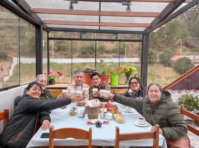 a group of people sitting at a table drinking wine at Casa Agustina in Cusco