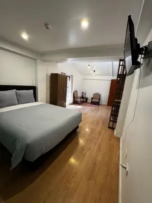 a bedroom with a bed and a flat screen tv at Casa Agustina in Cusco