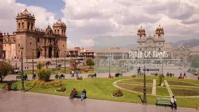 a group of people walking around a park in front of a building at Elsa Wasi Cusco in Cusco