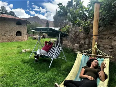 two women laying in a hammock in a yard at Illa Wasi Sacred Valley in Urubamba