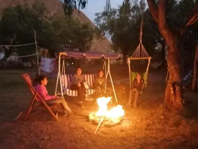 a group of people sitting around a fire at Illa Wasi Sacred Valley in Urubamba