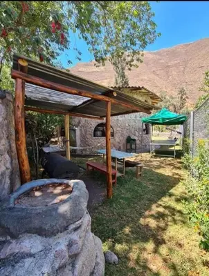 a pavilion with a fire pit in a yard at Illa Wasi Sacred Valley in Urubamba