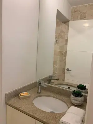 a bathroom with a sink and a mirror at Suite en San Isidro-Frente al Supermercado Vivanda in Lima