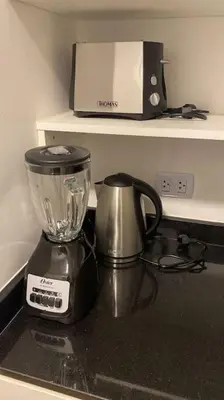 a blender sitting on top of a kitchen counter at Suite en San Isidro-Frente al Supermercado Vivanda in Lima