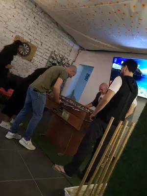 a group of men playing a video game in a room at JUMANA in Nazca