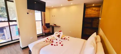 a bedroom with a bed with red hearts on it at Hotel Raices Machupicchu in Machu Picchu