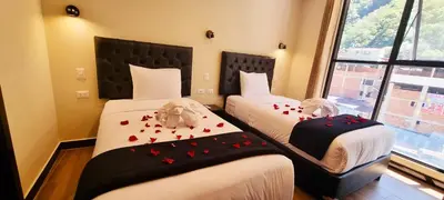 a bedroom with two beds with hearts on them at Hotel Raices Machupicchu in Machu Picchu