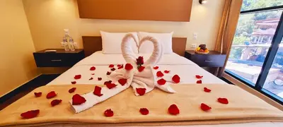 a bed with red hearts and towels on it at Hotel Raices Machupicchu in Machu Picchu