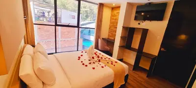 a hotel room with a bed and a large window at Hotel Raices Machupicchu in Machu Picchu