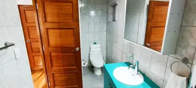 a bathroom with a toilet and a sink and a mirror at 7th Wonder Apart Hotel Cusco in Cusco