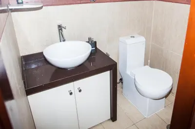 a bathroom with a sink and a toilet at Beautiful Penthouse in Lima, in front of the park in Lima