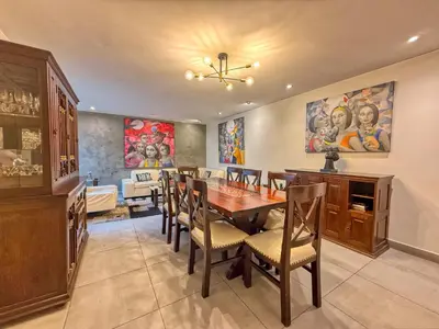 a dining room with a table and chairs at Beautiful Penthouse in Lima, in front of the park in Lima