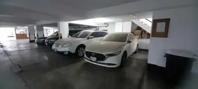a garage with two cars parked in it at Beautiful Penthouse in Lima, in front of the park in Lima