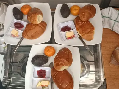 four plates of pastries and desserts on a table at SK Hostal in Cusco