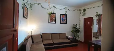 a living room with a couch in a room at SK Hostal in Cusco