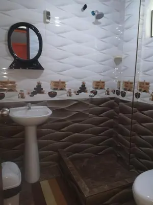 a bathroom with a sink and a mirror at Hostal Sol de Chosica in Chosica